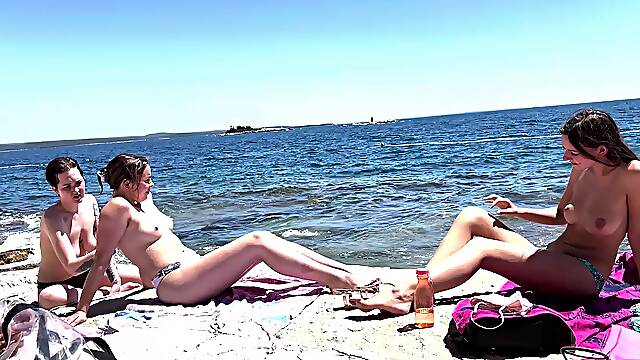 Two sexy lesbian teens playing with a vibrator on the beach